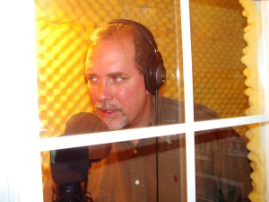 Working the mic in Total Broadcasting Service's former studio booth.